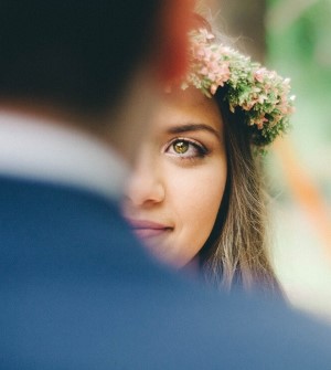 Bride with flower crown looking into groom's eyes