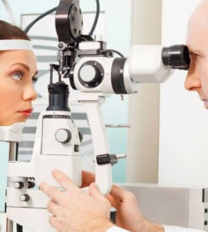 Optom giving woman an eye exam